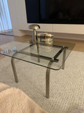 Table basse 100 x 60 cm en verre transparent et métal argenté style contemporain